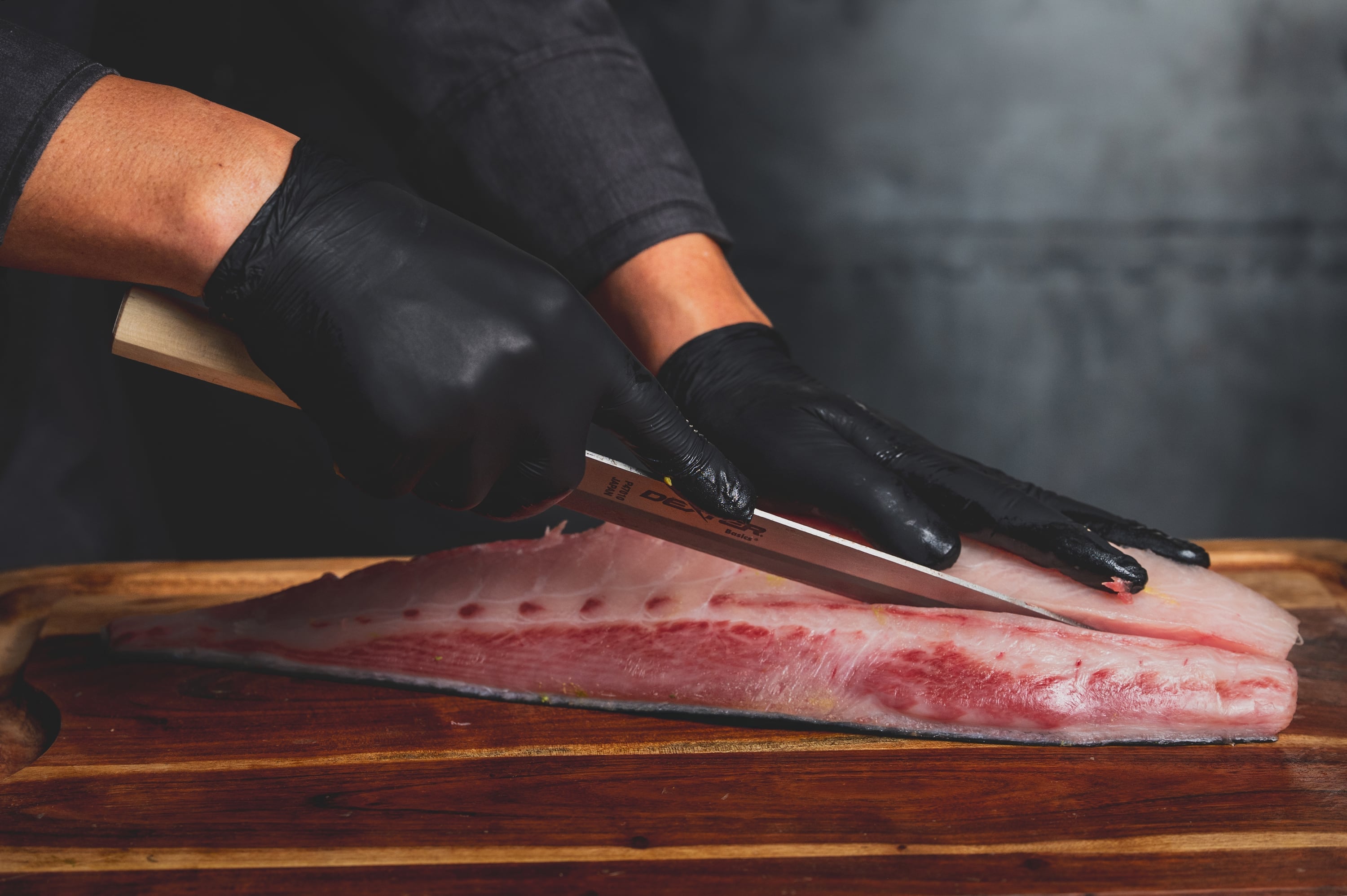 Chef hands cutting yellowtail