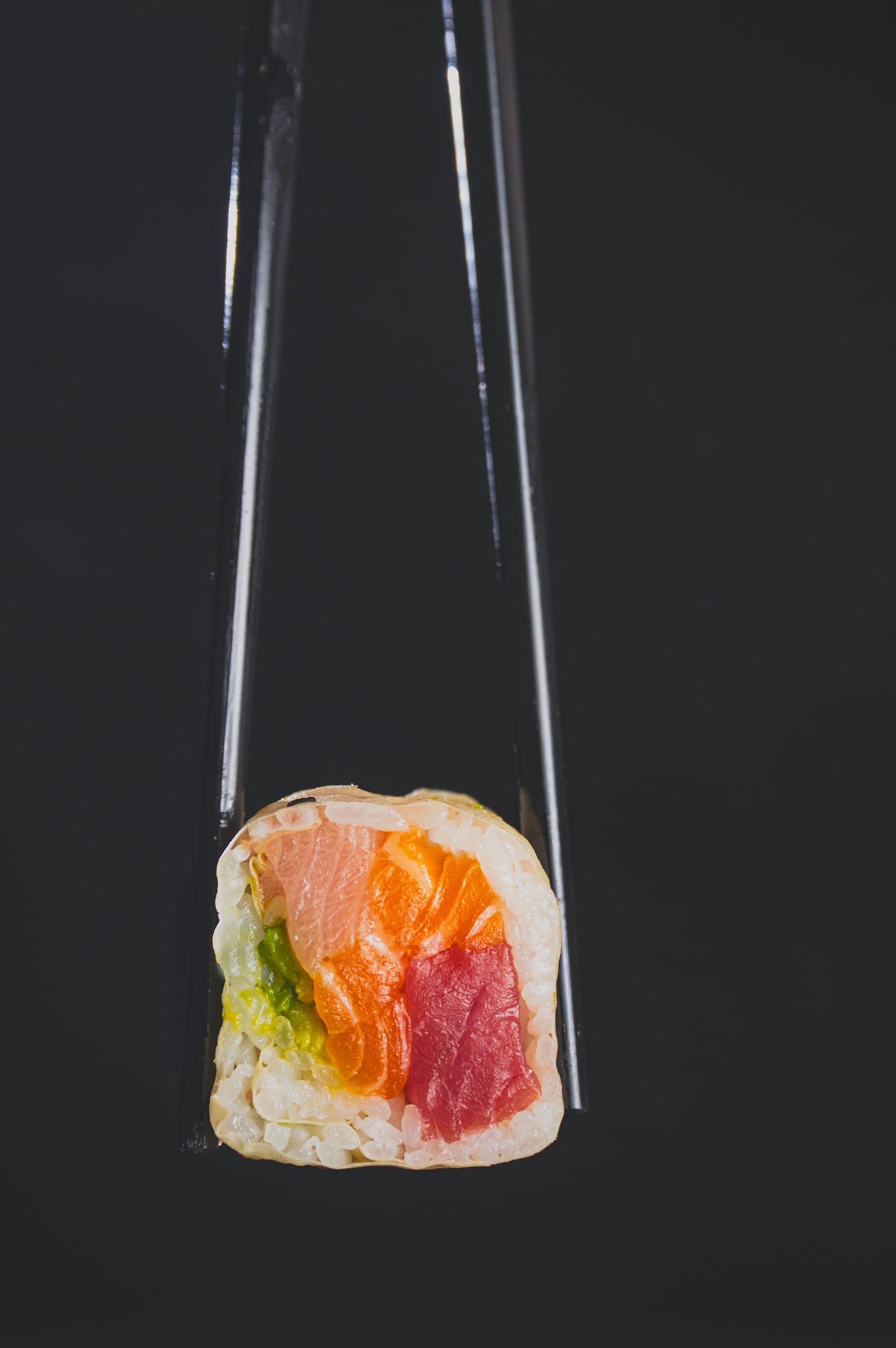 Futomaki cross-section held with chopsticks